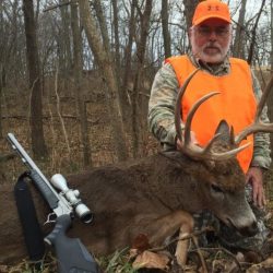 Dan Fall from Milton, FL poses with his Illinois muzzle loader trophy and the proper blaze orange requirements for the firearm season.